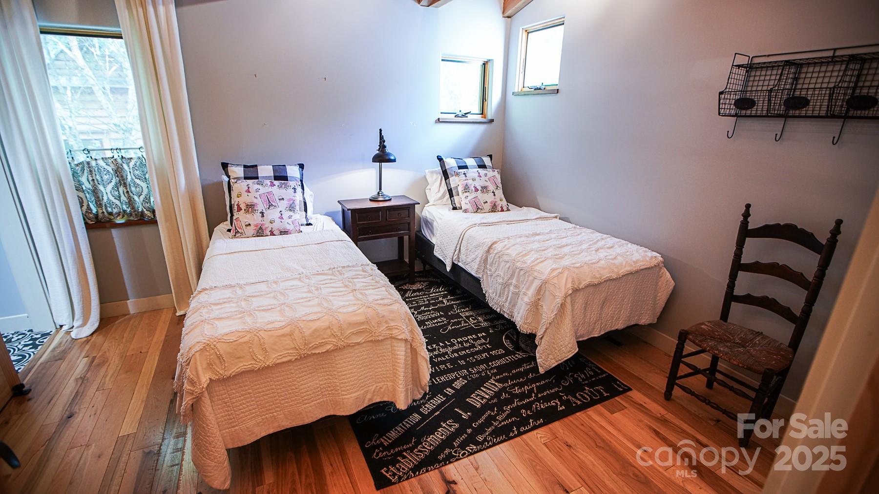 1048 South River Road Sylva, NC 28779 - Photo 21 of 42 a bedroom with bed and wooden floor