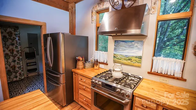 a kitchen with stainless steel appliances granite countertop a refrigerator and a stove