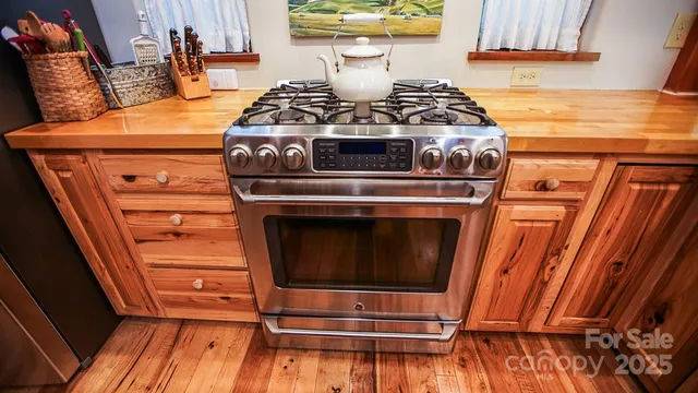 a stove top oven sitting inside of a kitchen