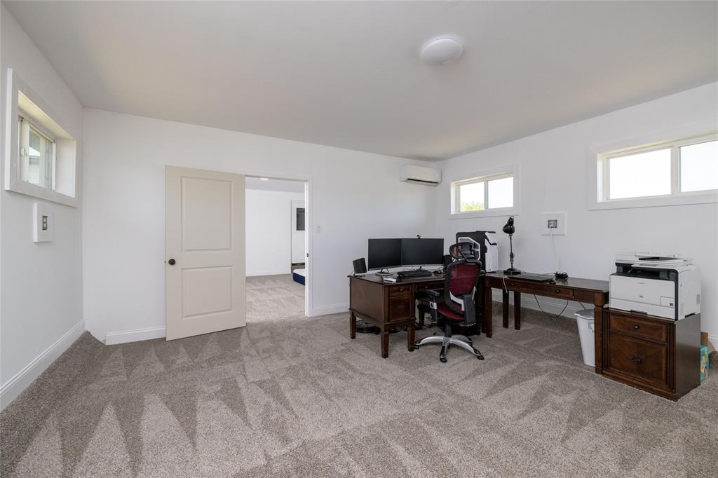 151 County Road 3699 Springtown, TX 76082 - Photo 24 of 35 Spacious room featuring neutral carpet flooring, white walls, and multiple windows