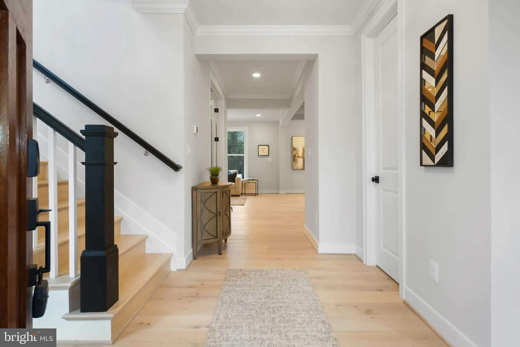 4617 Saul Road Kensington, MD 20895 - Photo 2 of 8 a view of a hallway with wooden floor and staircase