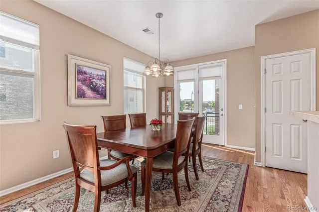 a dining room with furniture window and wooden floor