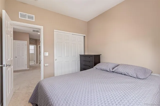 a bedroom with a bed and cabinet