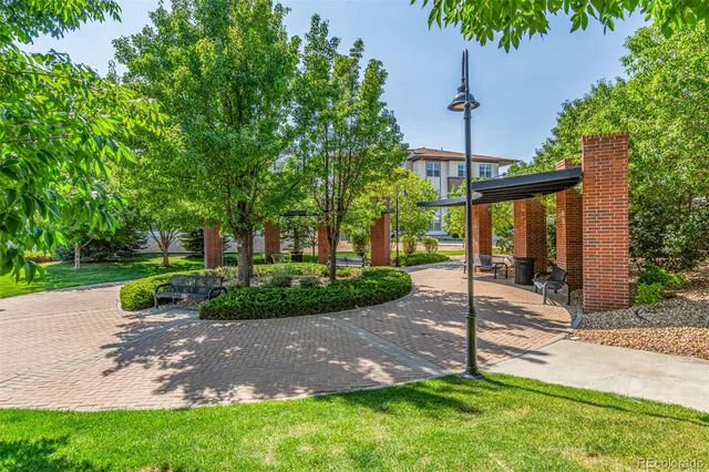 a view of a house with a yard and tree s