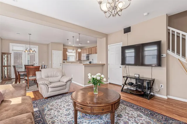 a living room with furniture and a chandelier
