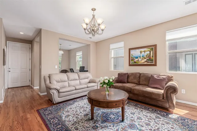 a living room with furniture and a chandelier