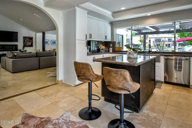 a kitchen with granite countertop a counter space a sink appliances and cabinets