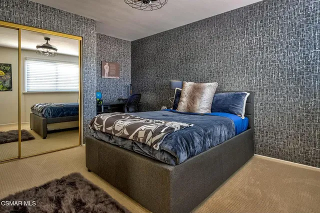 a en suite bathroom with a granite countertop sink and a mirror
