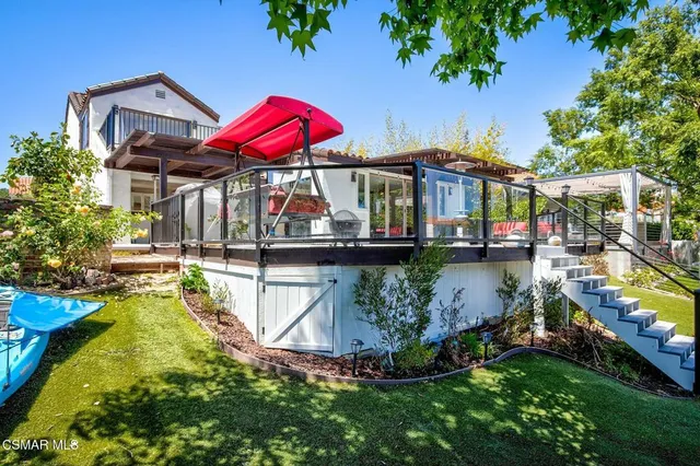 a view of a swimming pool with a patio and a garden