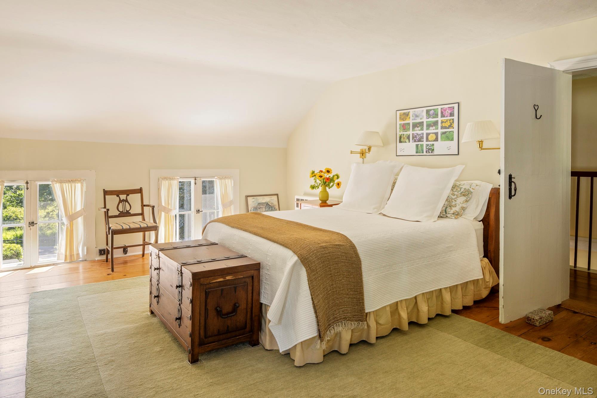 425 Camby Road Millbrook, NY 12545 - Photo 23 of 39 a spacious bedroom with a bed and a night stand