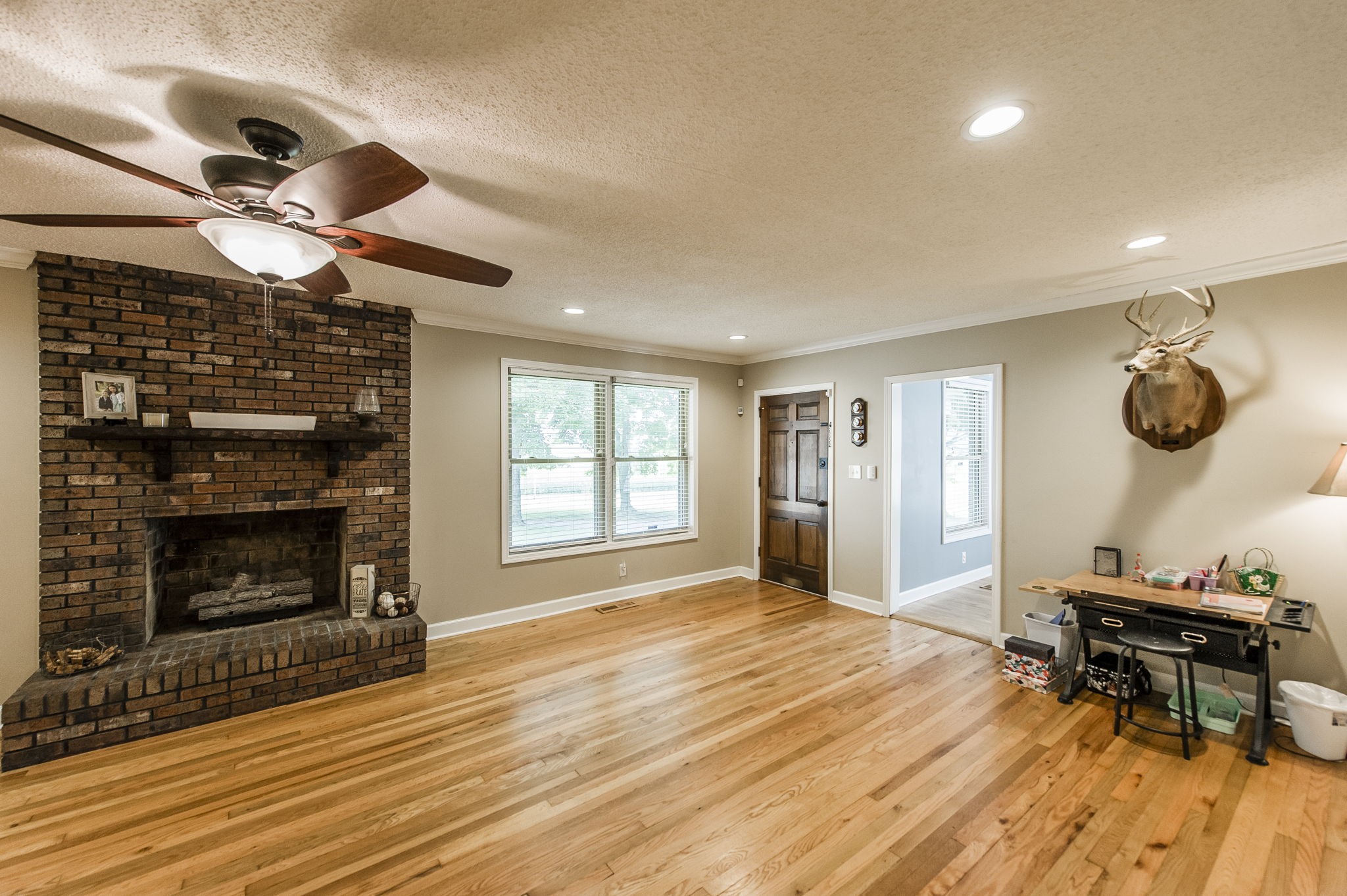 4131 Corbin Sneed Road Springfield, TN 37172 - Photo 15 of 52 a living room with furniture a fireplace and a flat screen tv