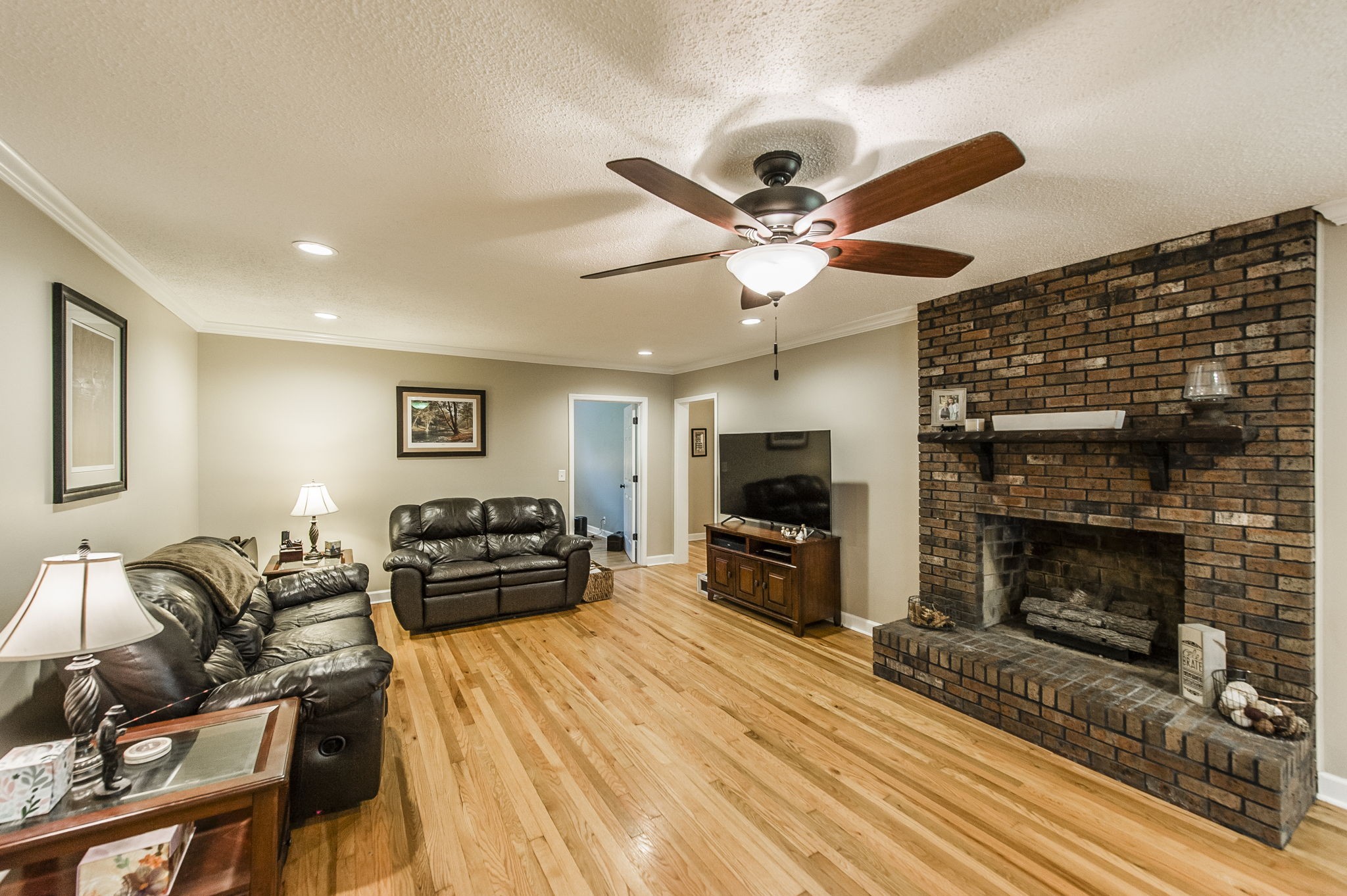 4131 Corbin Sneed Road Springfield, TN 37172 - Photo 16 of 52 a bedroom with furniture a flat screen tv and a fireplace