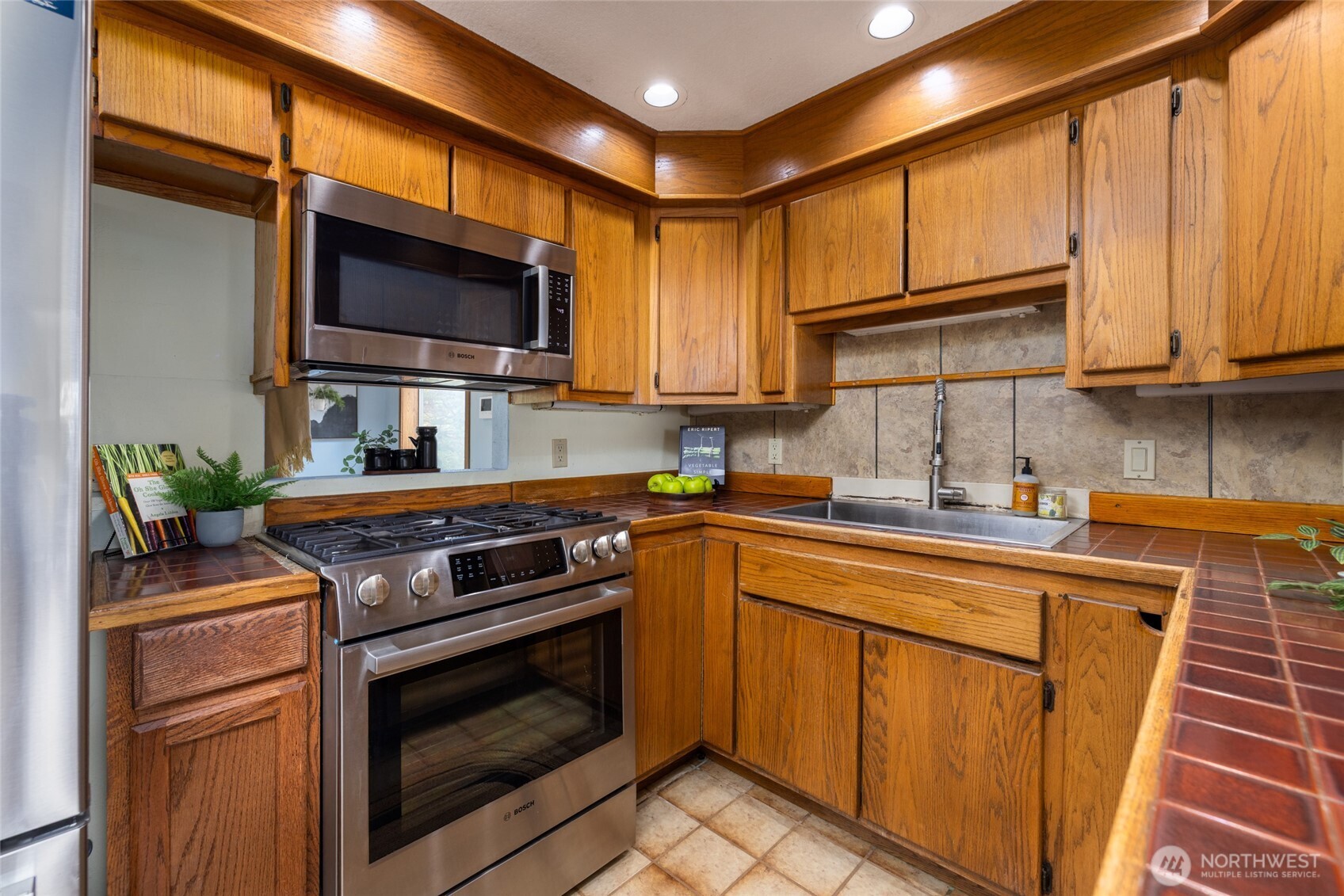 2496 Yew Street Road Bellingham, WA 98229 - Photo 11 of 38 a kitchen with stainless steel appliances granite countertop a stove microwave and sink