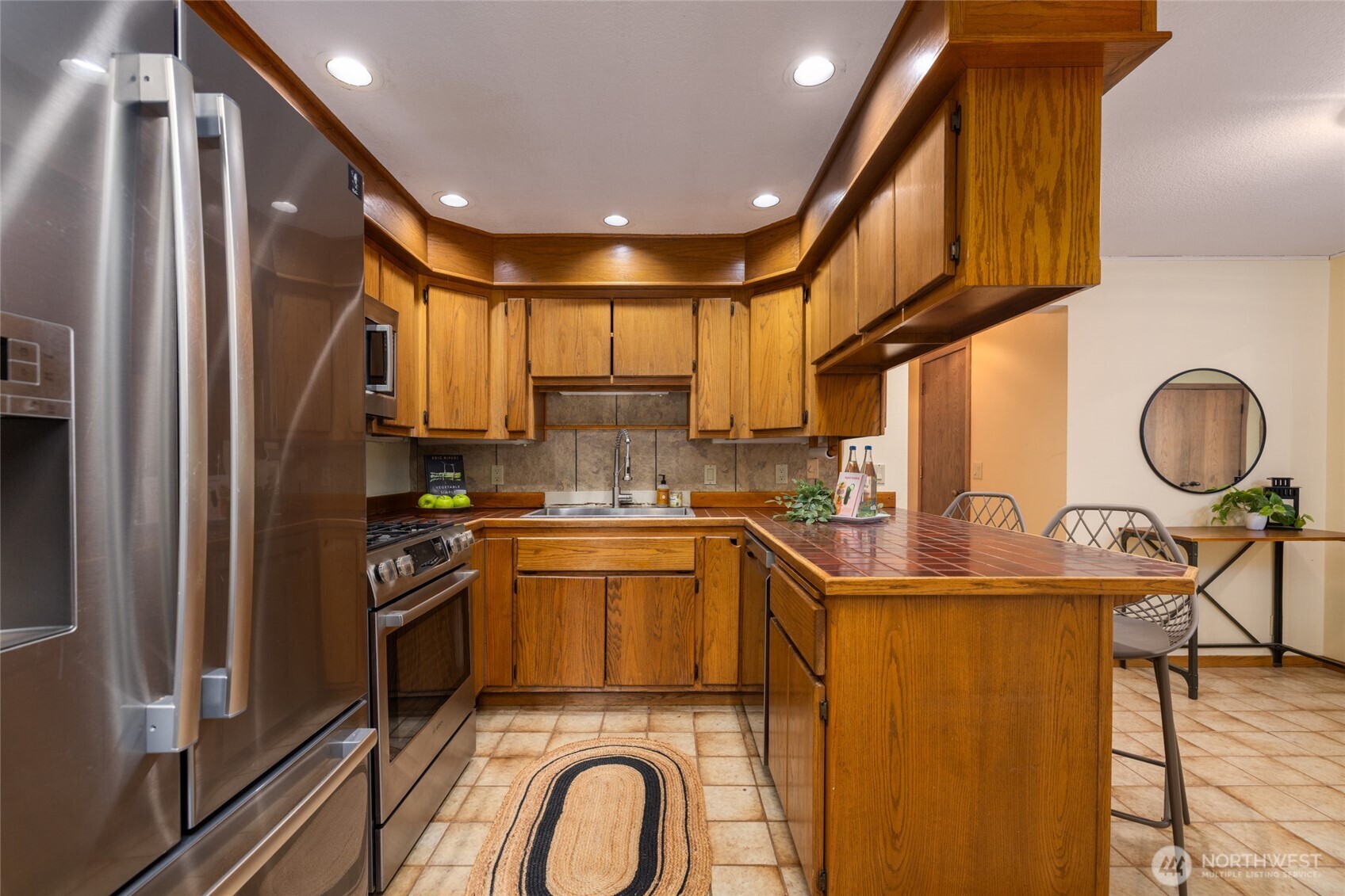 2496 Yew Street Road Bellingham, WA 98229 - Photo 12 of 38 a kitchen with stainless steel appliances granite countertop a sink a stove and a refrigerator
