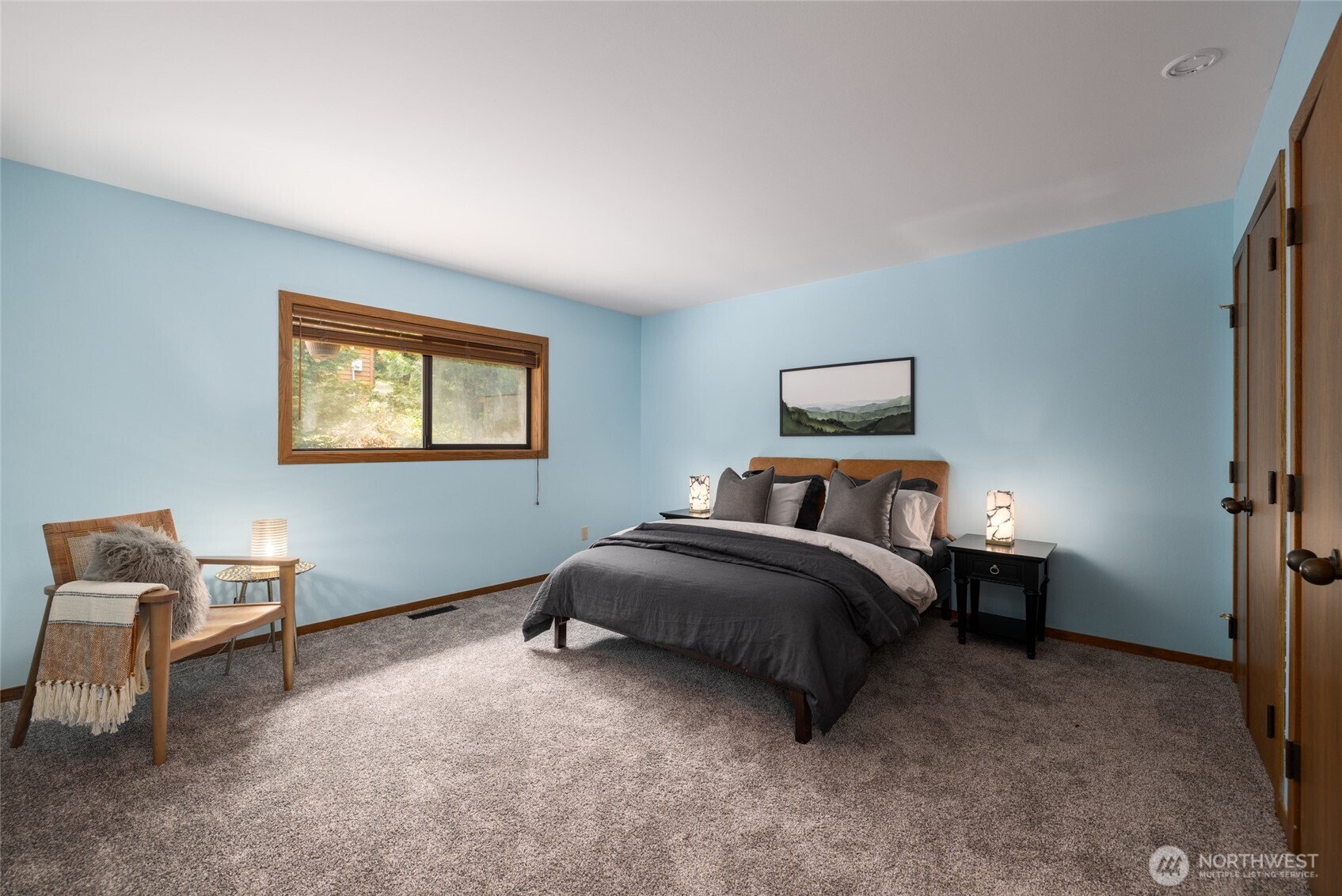 2496 Yew Street Road Bellingham, WA 98229 - Photo 16 of 38 a spacious bedroom with a bed and a lamp on desk