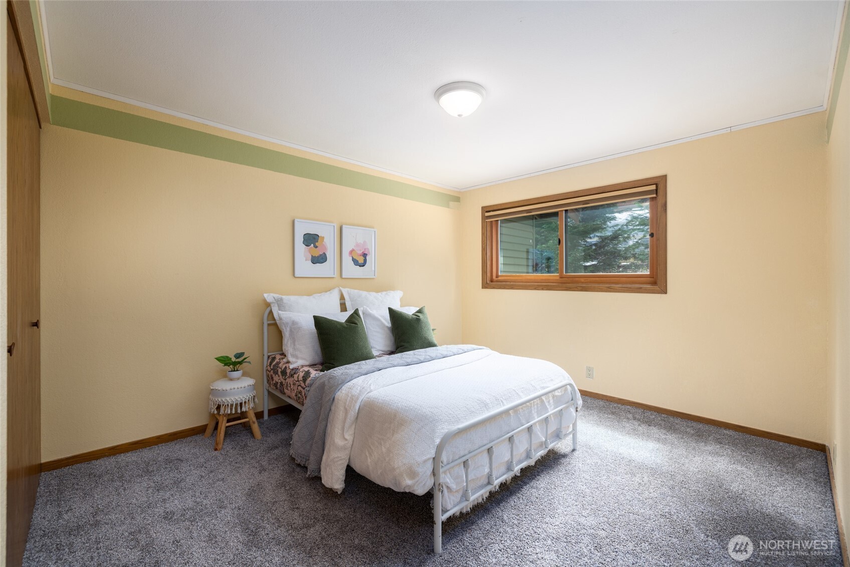 2496 Yew Street Road Bellingham, WA 98229 - Photo 22 of 38 a bed room with a bed and a painting on the wall