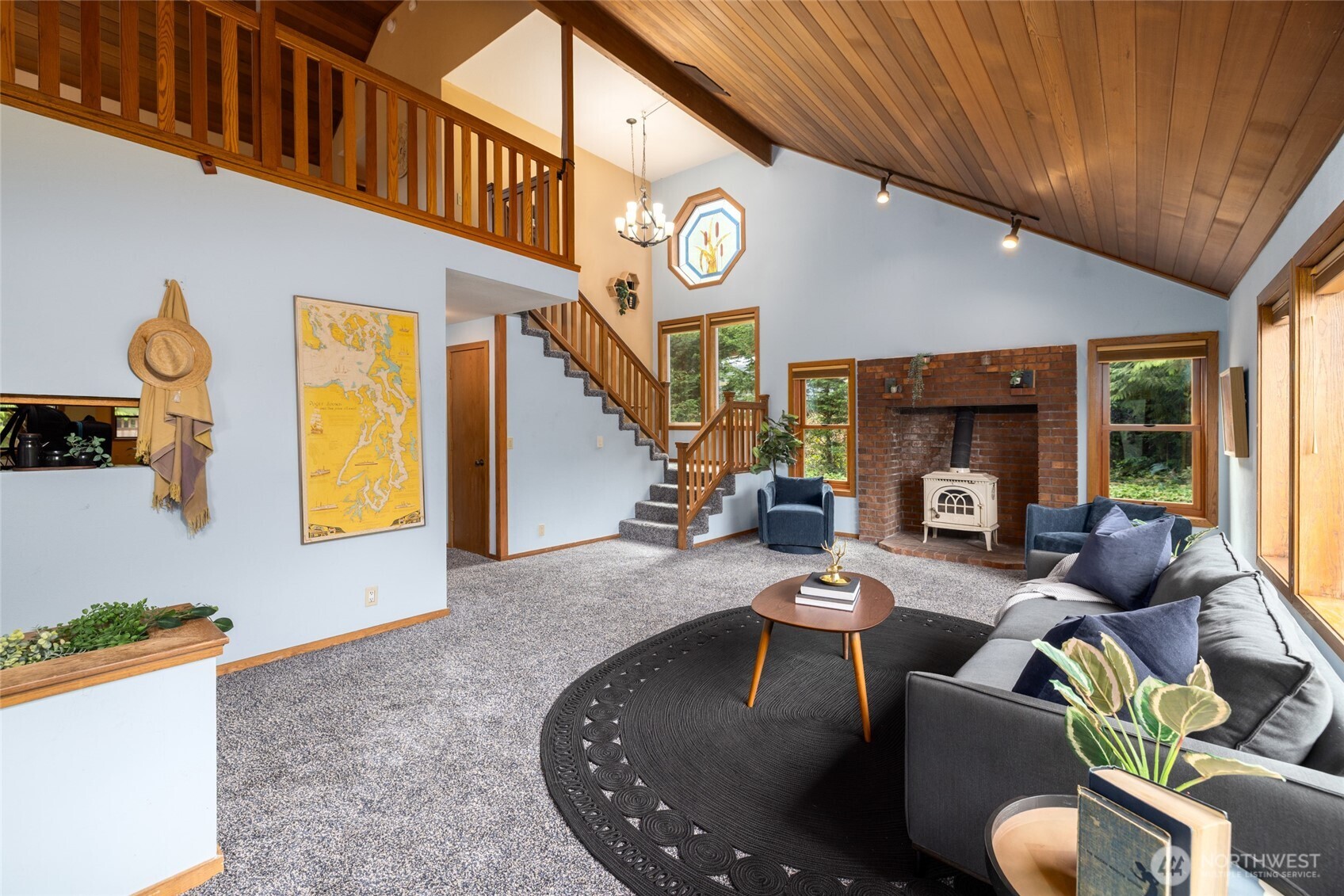 2496 Yew Street Road Bellingham, WA 98229 - Photo 5 of 38 a living room with furniture a fireplace and a large window