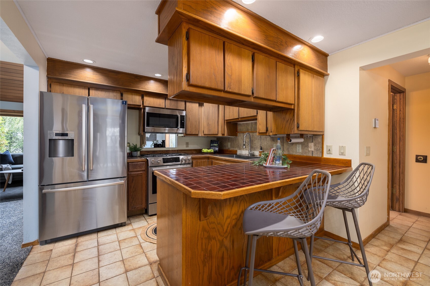 2496 Yew Street Road Bellingham, WA 98229 - Photo 9 of 38 a kitchen with stainless steel appliances granite countertop a refrigerator a sink dishwasher a stove and a refrigerator