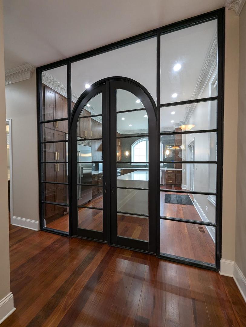 2150 West Monroe Street Chicago, IL 60612 - Photo 31 of 107 an empty room with wooden floor and door