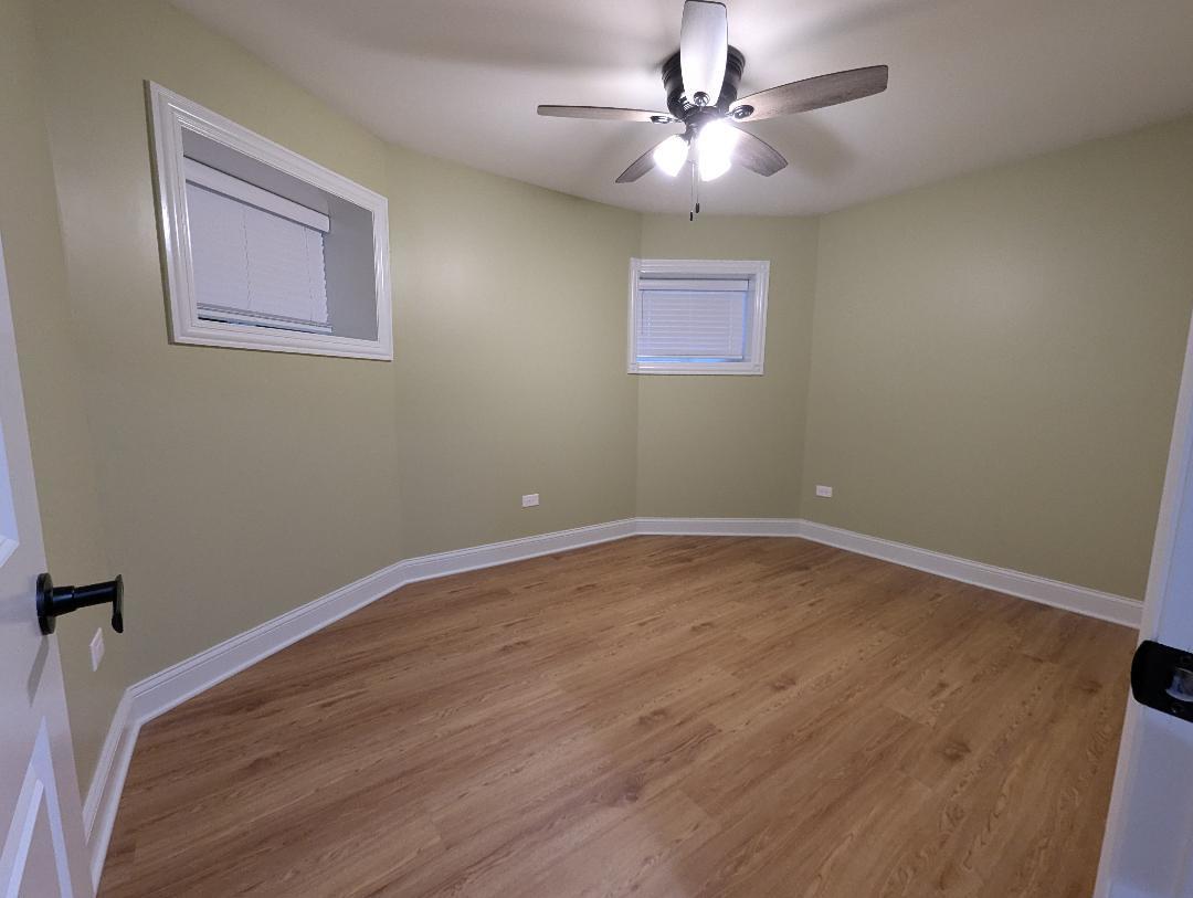 2150 West Monroe Street Chicago, IL 60612 - Photo 95 of 107 a view of a room with wooden floor and a ceiling fan