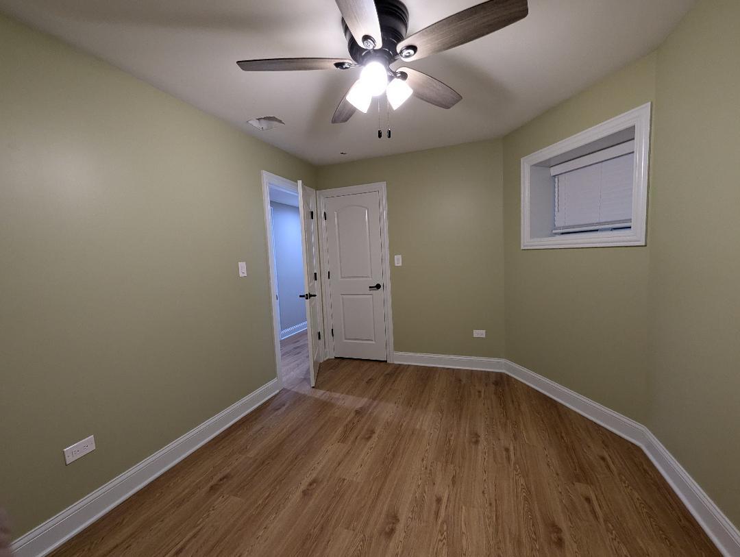 2150 West Monroe Street Chicago, IL 60612 - Photo 96 of 107 a view of a room with wooden floor and a ceiling fan