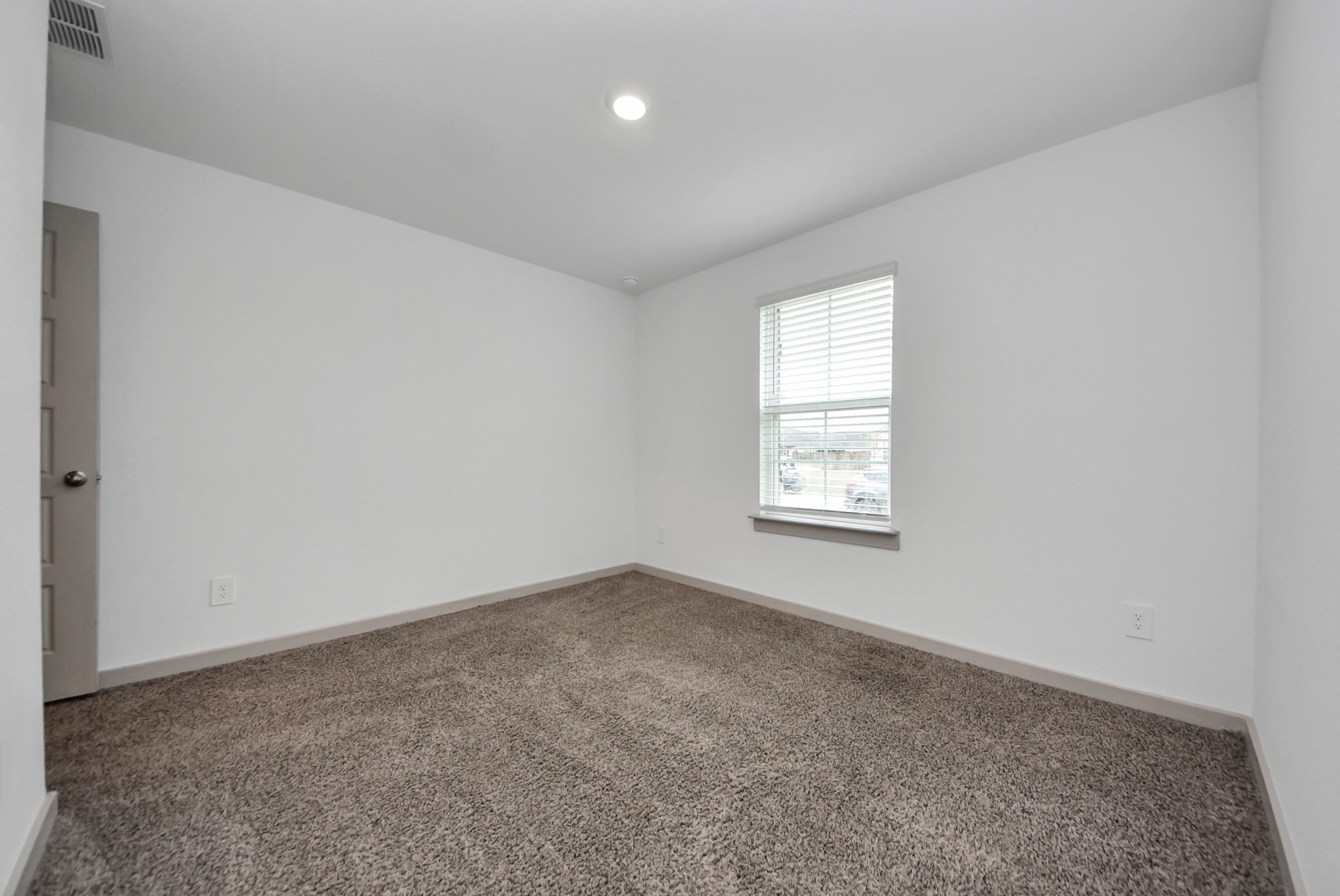 7911 Wrangler Shack Lane Rosharon, TX 77583 - Photo 11 of 40 Cozy bedroom with plush carpeting and a large window that brightens the space.