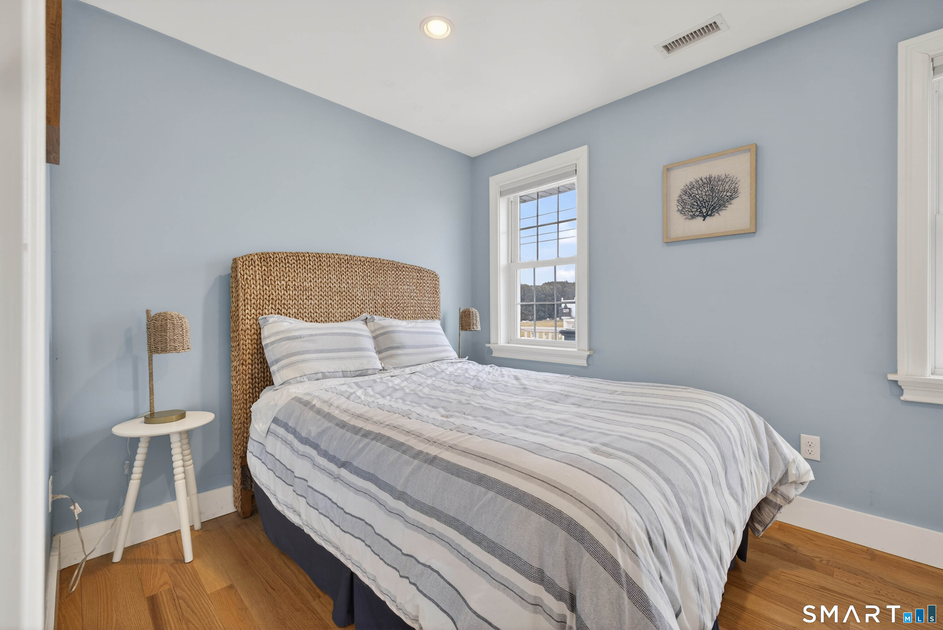 2 Pequot Trail Old Saybrook, CT 06475 - Photo 21 of 37 a bedroom with a bed and a lamp on dresser with wooden floor