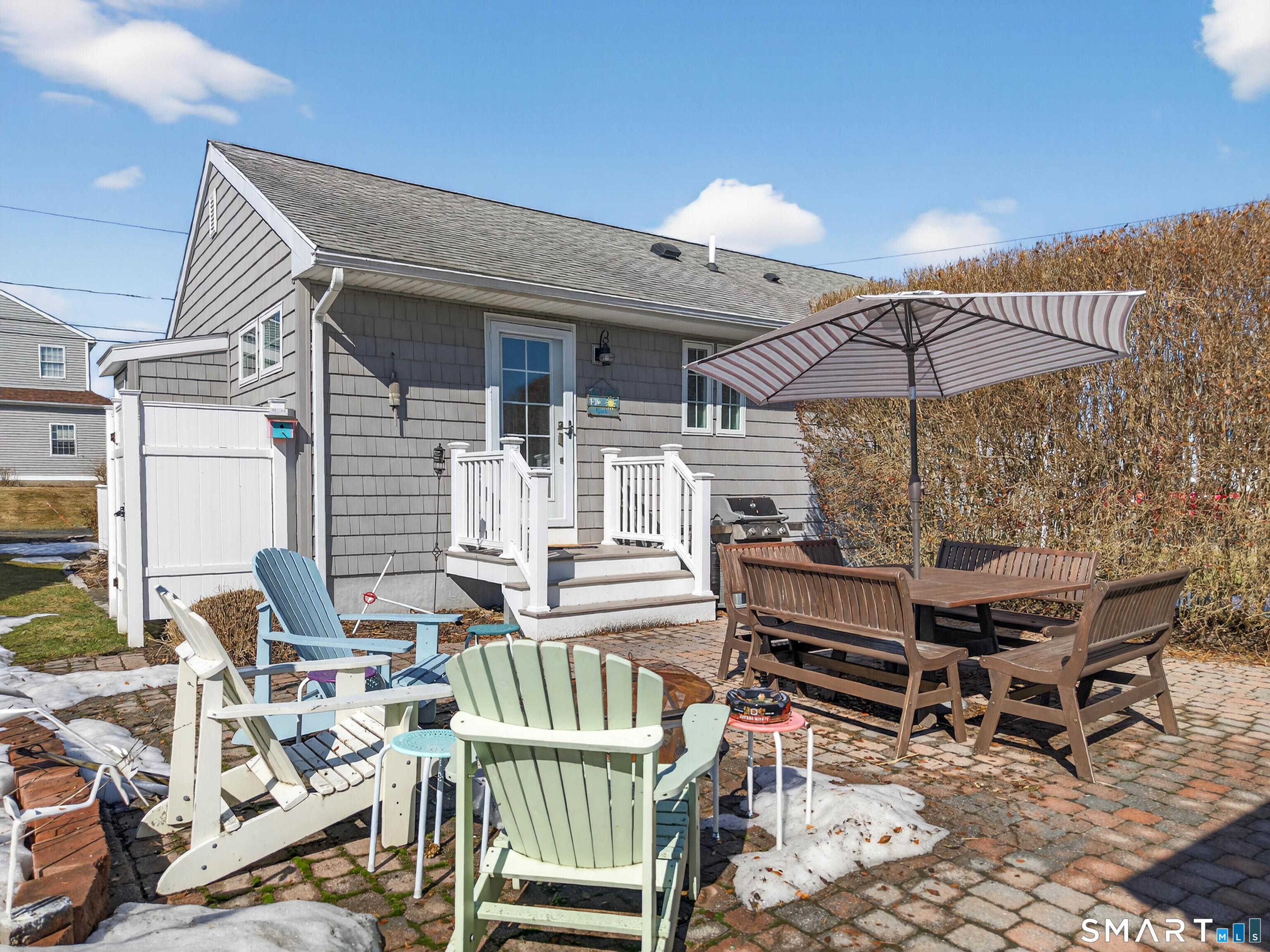 2 Pequot Trail Old Saybrook, CT 06475 - Photo 7 of 37 a patio with a table and chairs under an umbrella