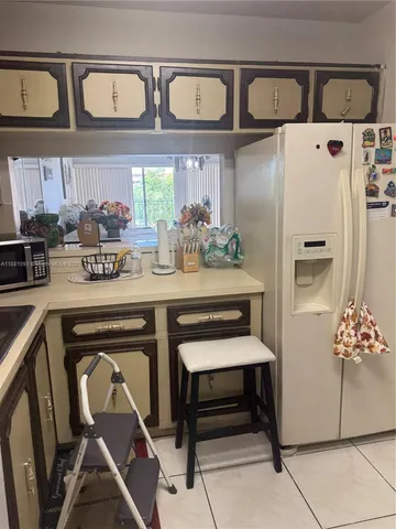 a stove top oven sitting inside of a kitchen