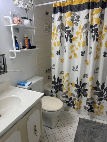 a bathroom with a sink toilet and mirror