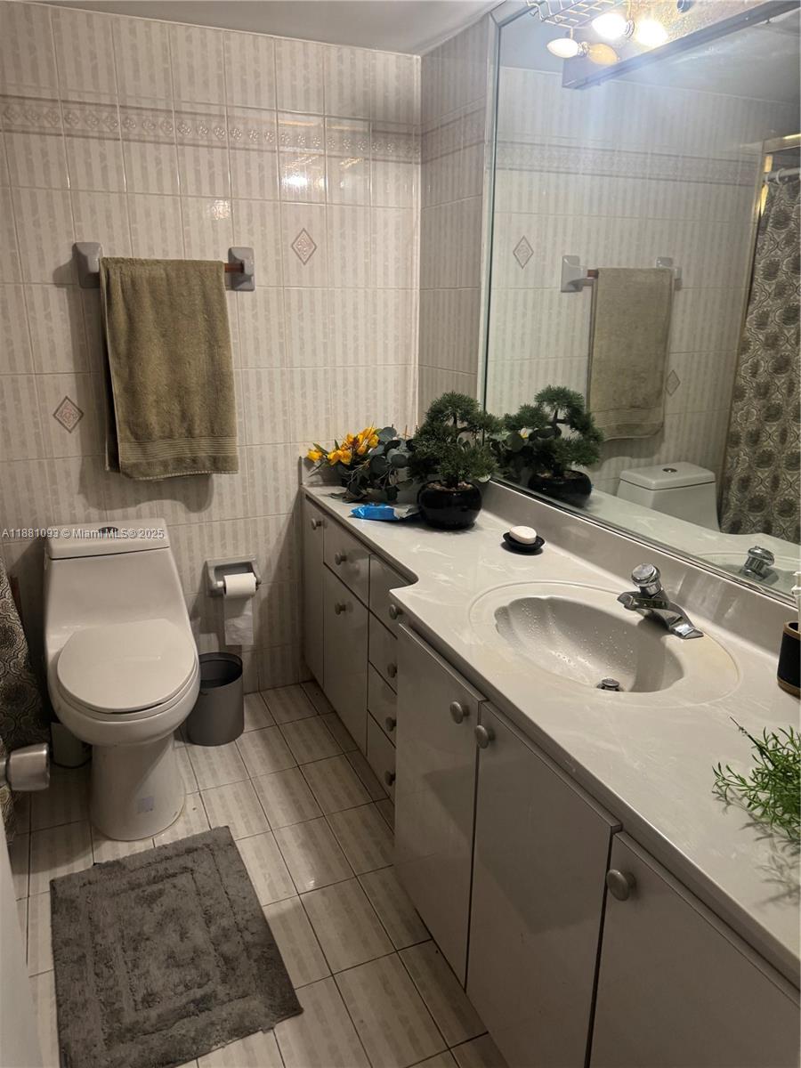 1975 West 44th Place, Unit 505 Hialeah, FL 33012 - Photo 19 of 28 a bathroom with a sink double vanity and a toilet