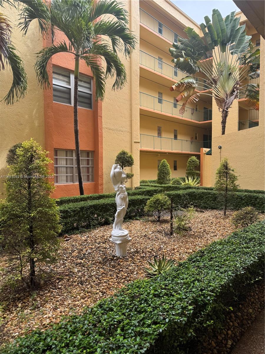 1975 West 44th Place, Unit 505 Hialeah, FL 33012 - Photo 2 of 28 a bench sitting in front of a building