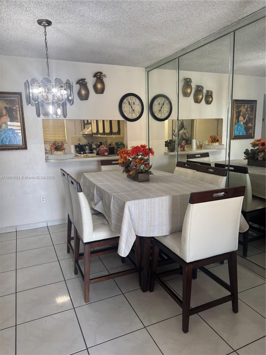 1975 West 44th Place, Unit 505 Hialeah, FL 33012 - Photo 21 of 28 a view of a dining room furniture and chandelier