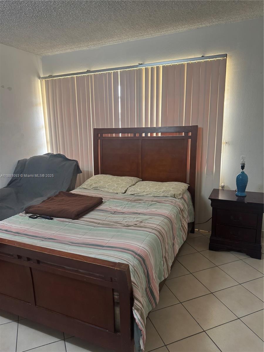 1975 West 44th Place, Unit 505 Hialeah, FL 33012 - Photo 25 of 28 a bedroom with a bed and a window