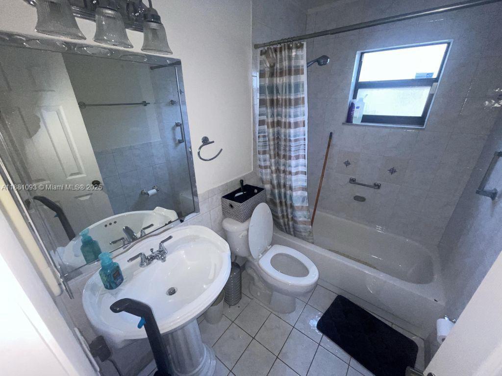 1975 West 44th Place, Unit 505 Hialeah, FL 33012 - Photo 28 of 28 a bathroom with a sink toilet and shower