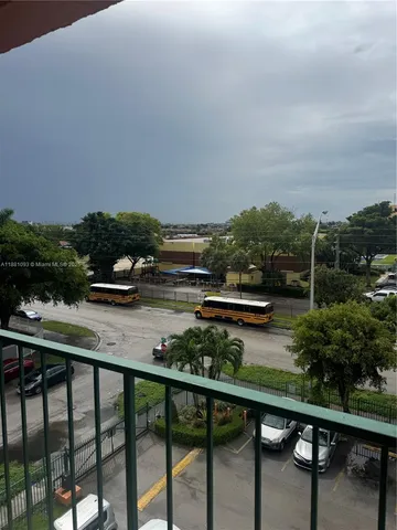 a view of kitchen with cabinets and window