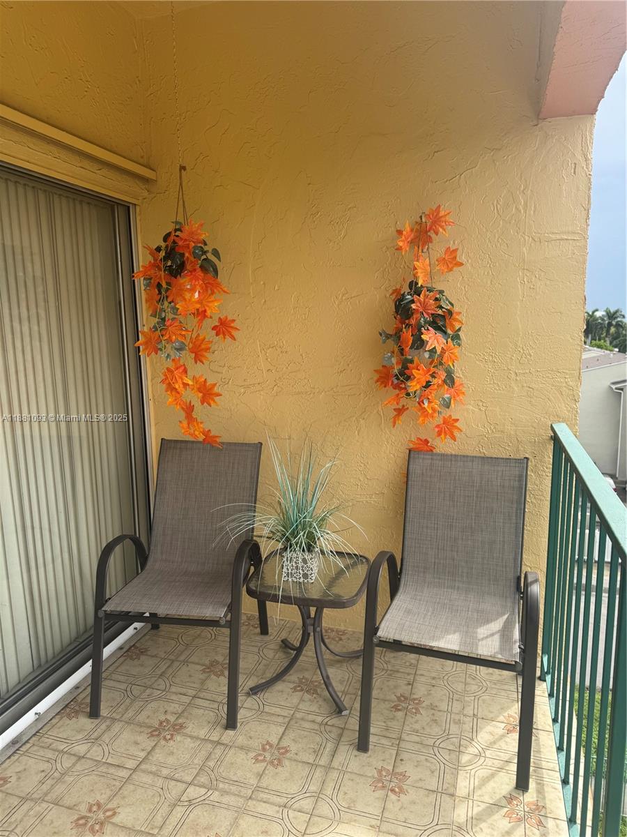 1975 West 44th Place, Unit 505 Hialeah, FL 33012 - Photo 7 of 28 a view of a chairs and table in the balcony