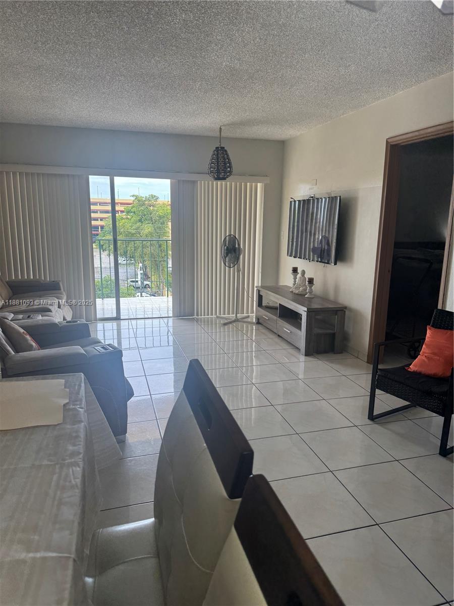 1975 West 44th Place, Unit 505 Hialeah, FL 33012 - Photo 8 of 28 a living room with furniture and a flat screen tv