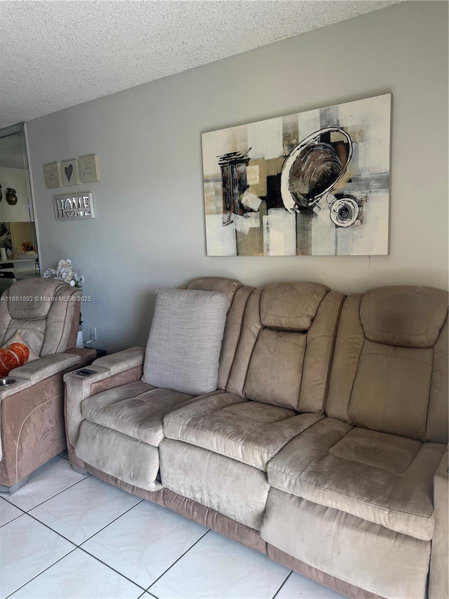 1975 West 44th Place, Unit 505 Hialeah, FL 33012 - Photo 10 of 28 a living room with furniture and painting on the wall