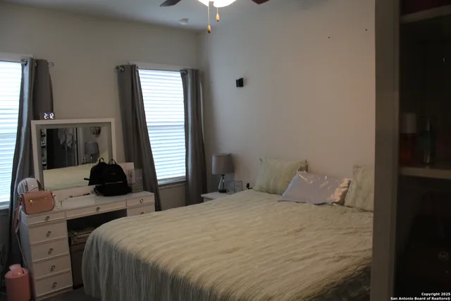 a bedroom with a bed and a window