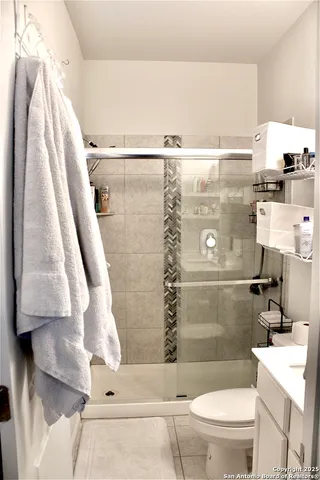 a bathroom with a shower a toilet and sink