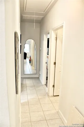 a view of a entryway door with hallway