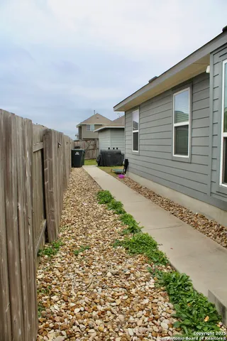 a view of a backyard of a house with a large tree