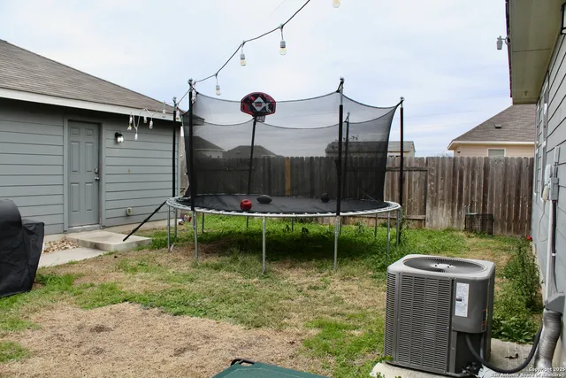 a backyard of a house with table and chairs
