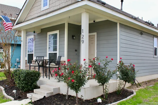 a view of a house with potted plants