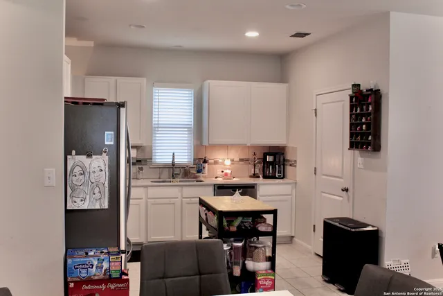 a kitchen with stainless steel appliances a refrigerator and a stove top oven