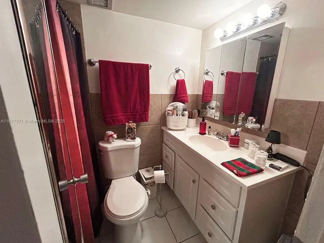 a bathroom with a sink vanity mirror and toilet