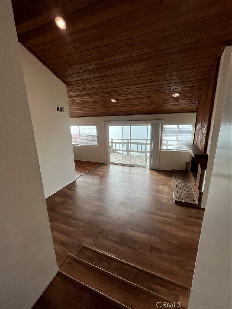 1532 Neptune Avenue Encinitas, CA 92024 - Photo 15 of 36 a view of wooden floor and windows in an empty room