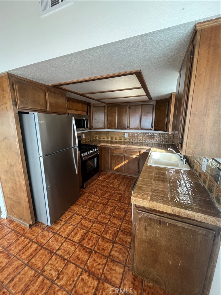 1532 Neptune Avenue Encinitas, CA 92024 - Photo 19 of 36 a kitchen with refrigerator and microwave