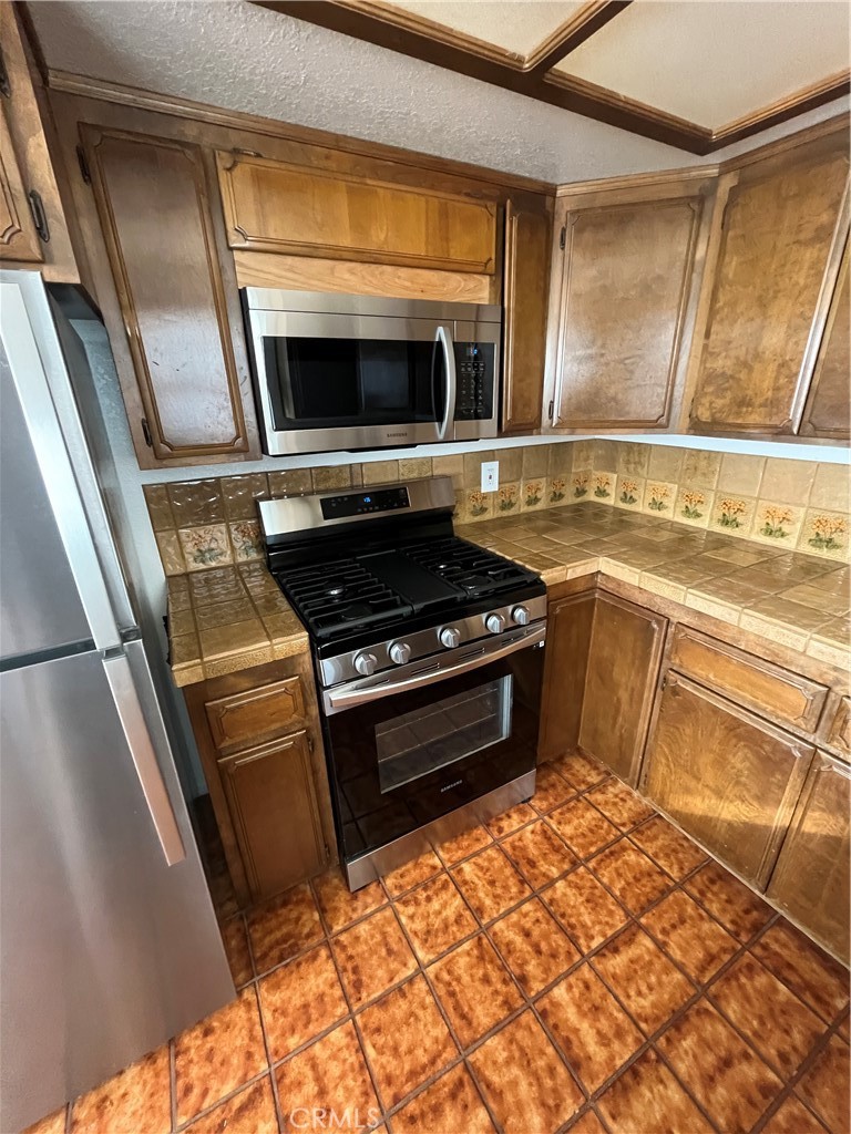 1532 Neptune Avenue Encinitas, CA 92024 - Photo 20 of 36 a kitchen with a stove and a microwave